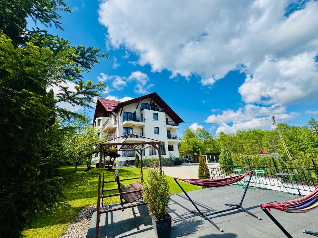 a house with two hammocks in front of it at Oana's Boutique in Bran