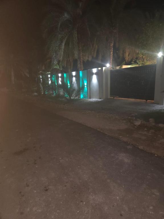 a house at night with lights on a fence at moon light in Ramlah