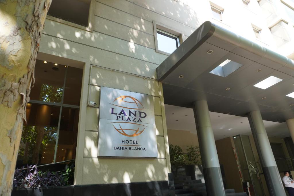 a building with a sign on the side of it at Land Plaza Hotel in Bahía Blanca