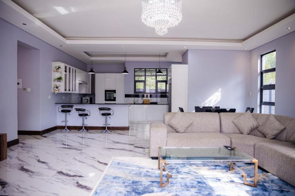a living room with a couch and a table at Oasis Apartment Suites in Ezulwini