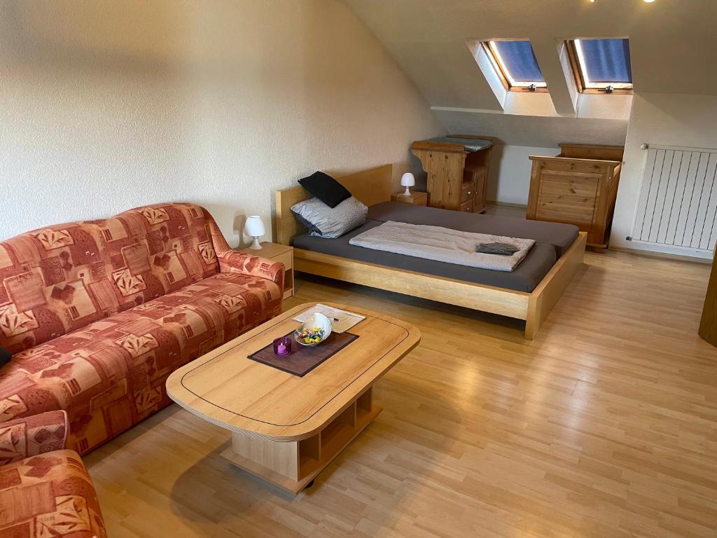 a room with a bed and a couch and a table at Ferienwohnung in Weilburg in Weilburg