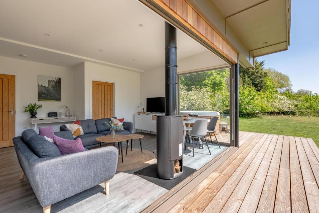 a living room with a couch and a fireplace at 2 Bed in Colchester oc-82397 in East Bergholt