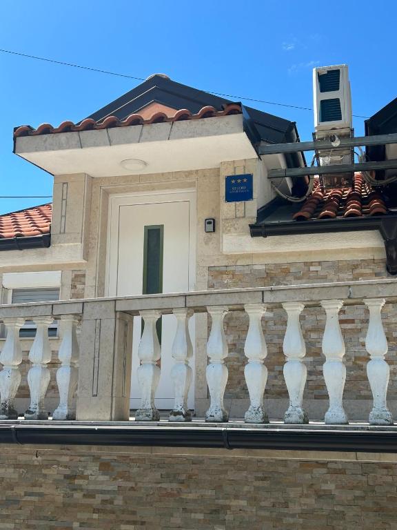 a balcony of a house with a camera on it at Apartment Barba in Bribir