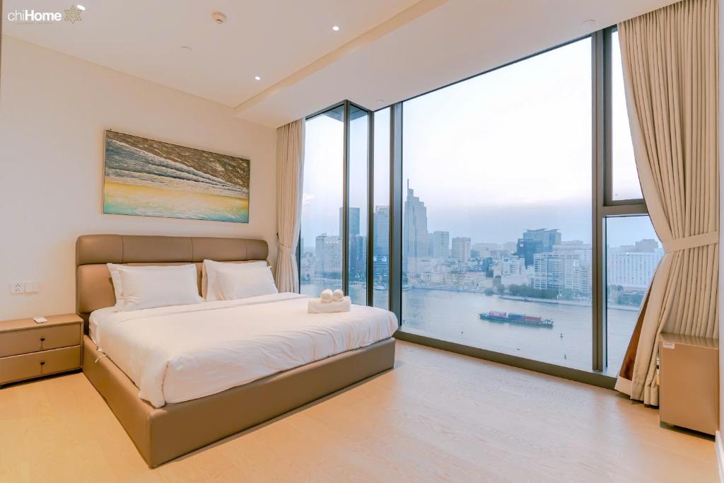 a bedroom with a bed and a large window at ChiHome Metropole The Opera Residence Luxury in Ho Chi Minh City