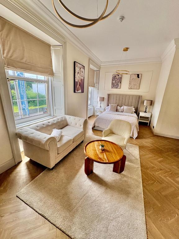 a large bedroom with a bed and a table at Flora in ApartNest Auchterarder in Auchterarder