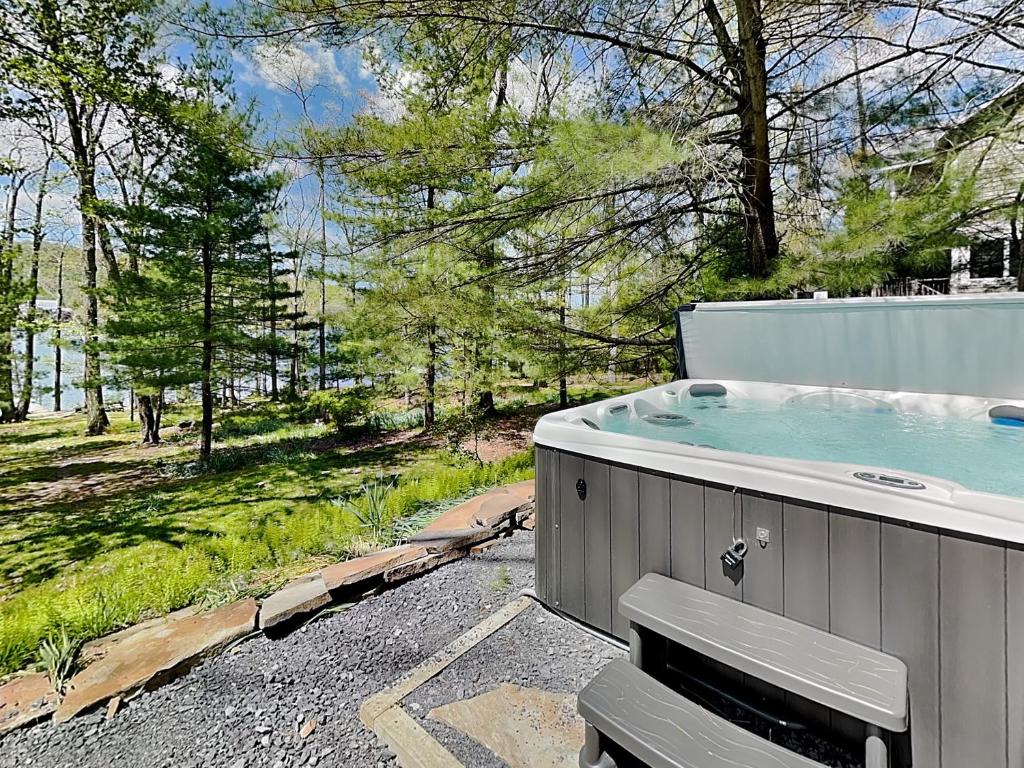 a hot tub in a backyard with a view of a field at Waltzing Matilda in Swanton
