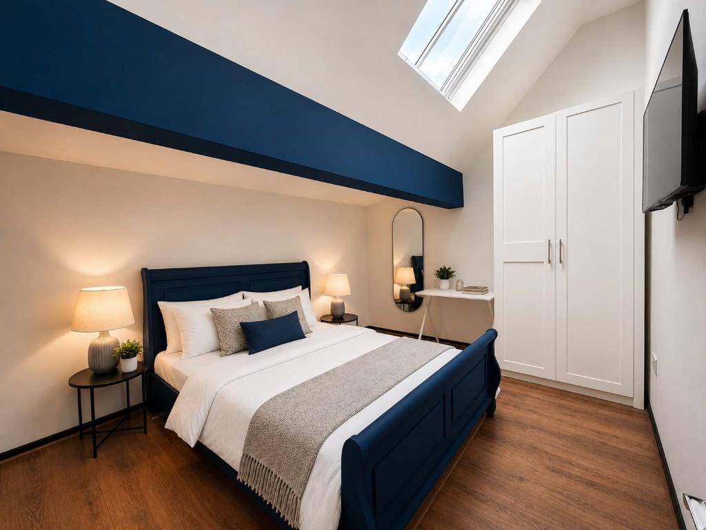 a bedroom with a large bed with a blue ceiling at The Regent in Warrington