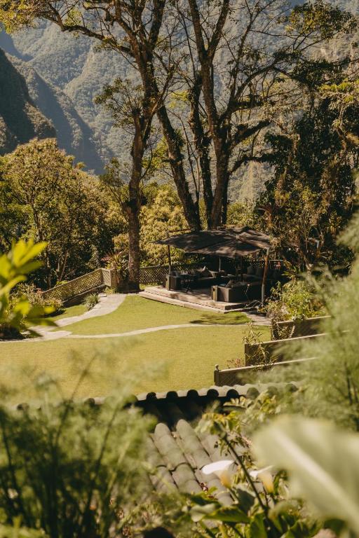 a park with a pavilion in the middle of a field at Sanctuary Lodge, A Belmond Hotel, Machu Picchu in Machu Picchu