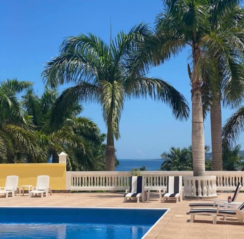 a resort with palm trees and a swimming pool at Spring Garden Ocean View in Montego Bay