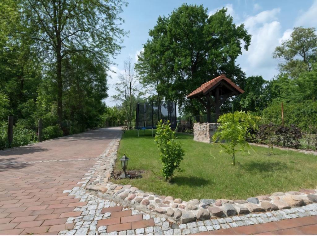 a brick road with a gazebo in a park at Spreeperle in Lübbenau