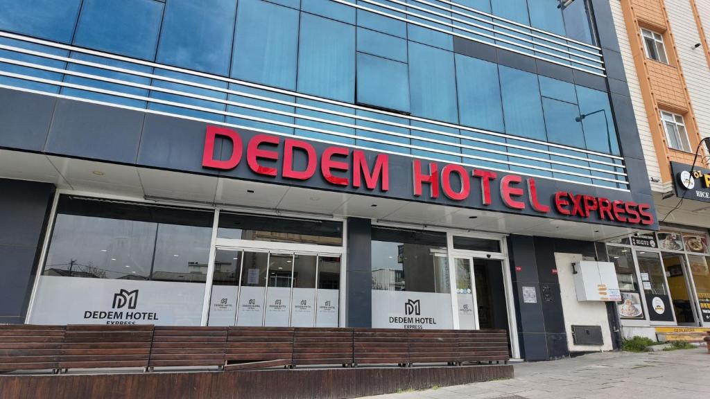 a hotel sign on the side of a building at Dedem Hotel Express-İstanbul Airport-Round Trip Airport Service in Arnavutköy