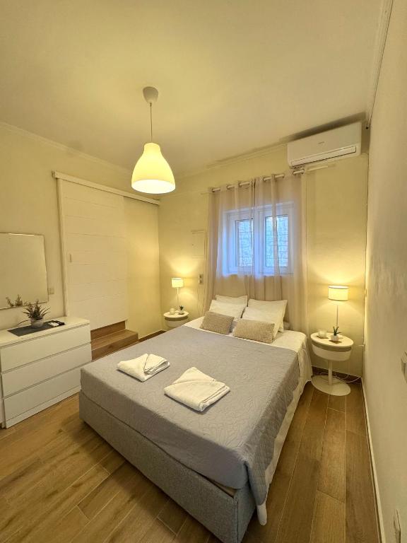 a bedroom with a bed with two towels on it at Spiros apartment - Loggos, Paxos in Longós