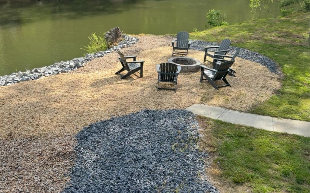 a group of chairs and a table next to a lake at Newport River Retreat in Ellijay
