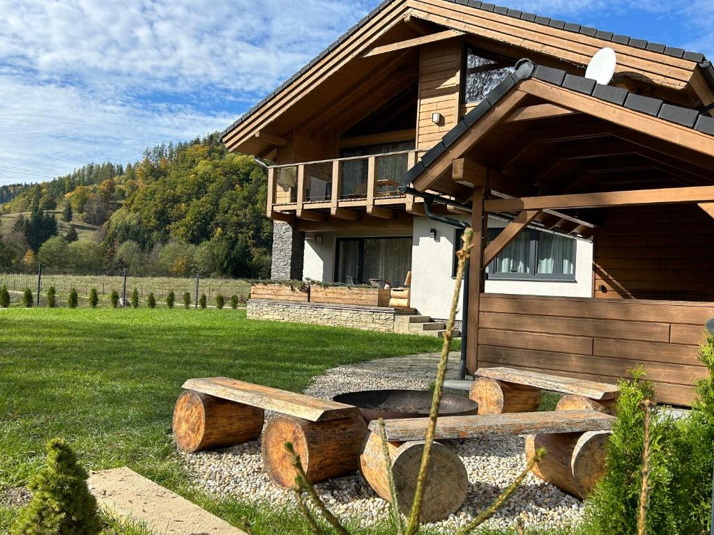 a log cabin with a bench in front of it at Chata LINDA in Mýto pod Ďumbierom