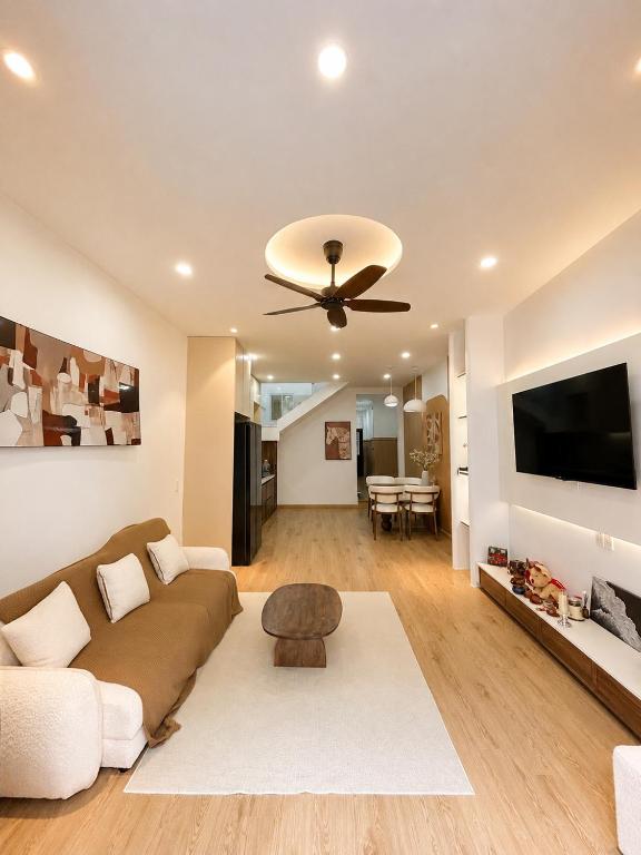 a living room with a couch and a ceiling fan at Linh's Home in Danang