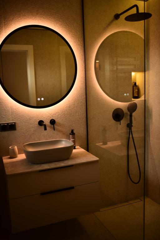 a bathroom with a sink and a mirror at Słoneczna Polana in Żabiczyn
