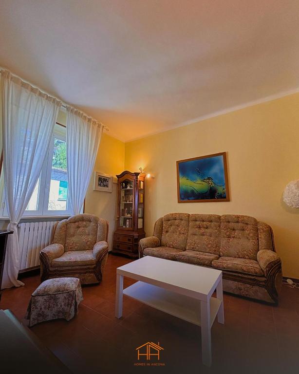 a living room with a couch and a coffee table at La Cameranense by Homes in Ancona in Camerano