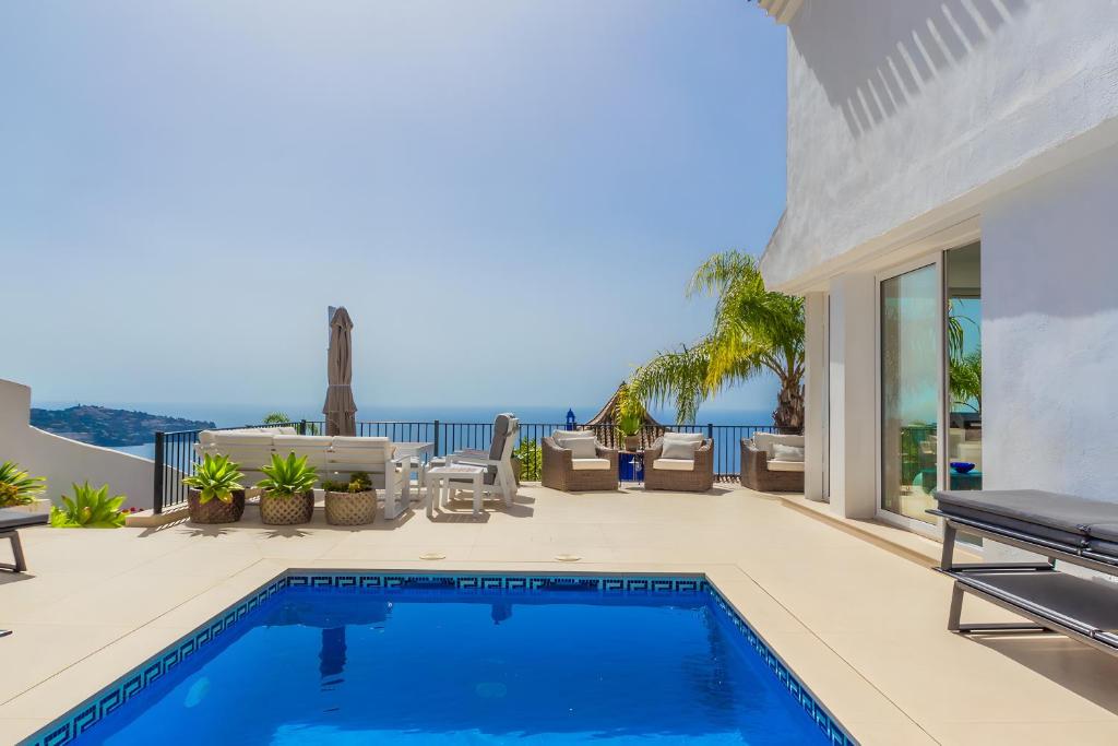 a swimming pool in a house with a view of the ocean at Los Altos in Almuñécar
