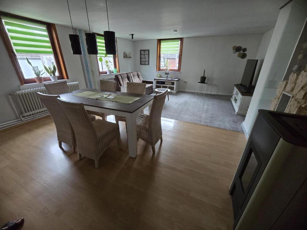 a living room with a dining room table and chairs at Apartment Schneider in Höxter