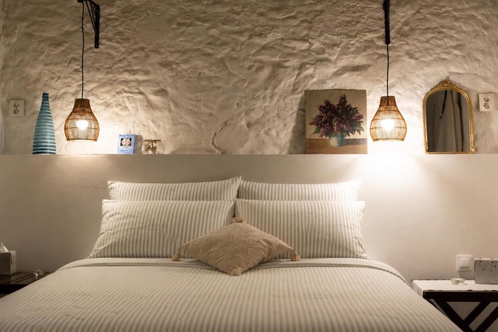 a bedroom with a white bed with three lights at Écurie de l oasis in Caux