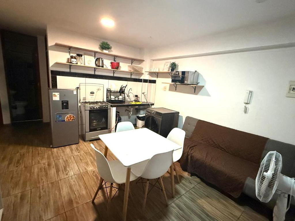 a kitchen and living room with a table and a couch at Comodidad en un solo lugar in Lima