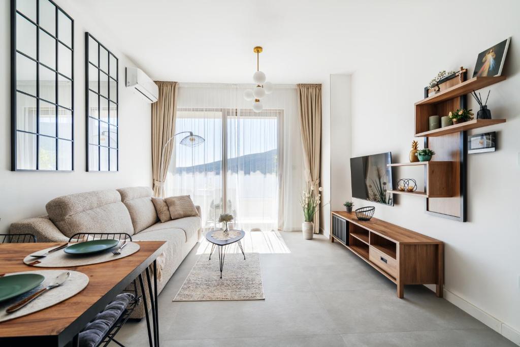 a living room with a couch and a table at Anna Luxury BELLA VISTA in Baošići