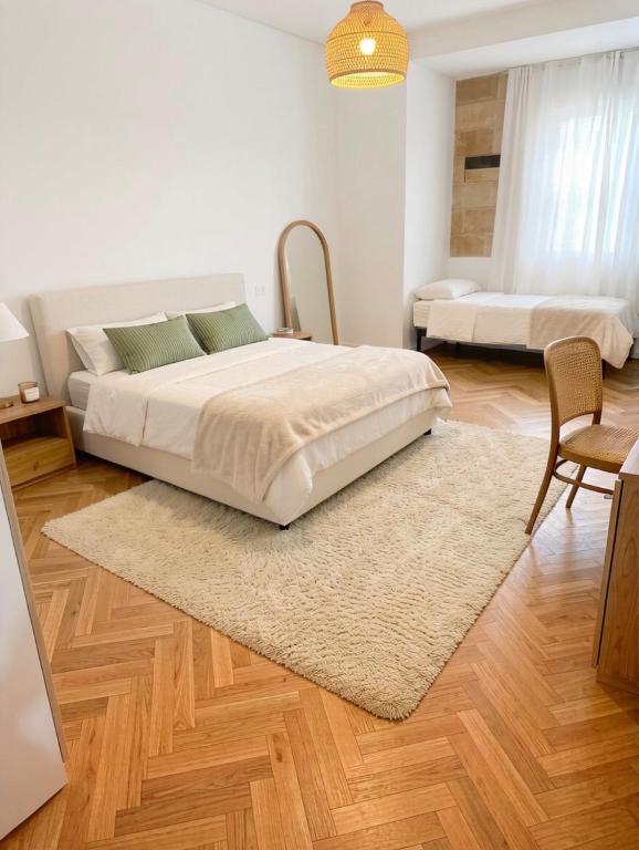 a bedroom with a large bed and a rug at Albergo Conca D'Oro in Foggia