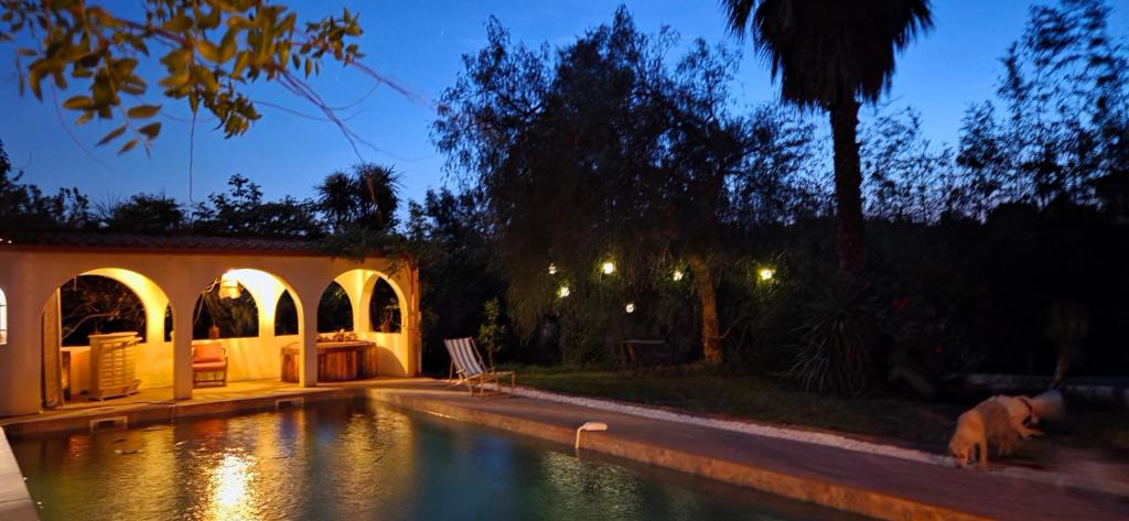a house with a swimming pool at night at Casa Esperanto in Béziers