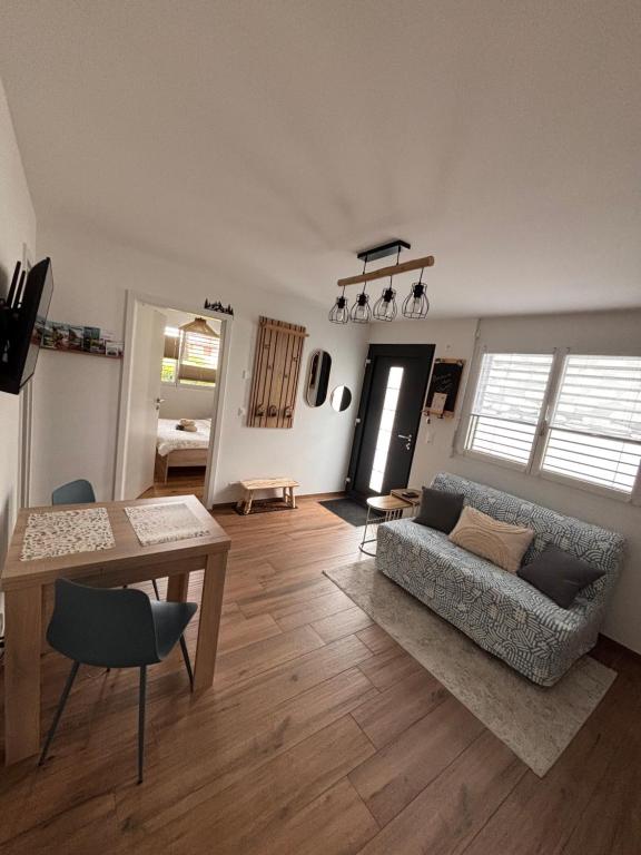 a living room with a couch and a table at Chez Baron in Hauterive