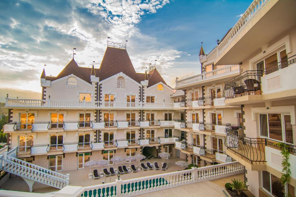 an aerial view of a large building with balconies at Камелот Отель in Malorechenskoye