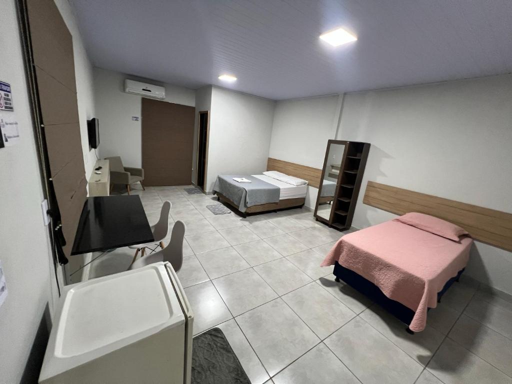 a hospital room with a bed and a sink at Apartamento privado in Primavera do Leste