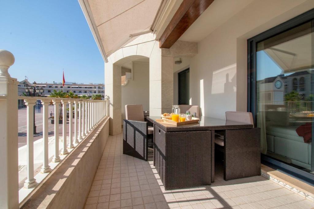 an outdoor patio with a table and chairs on a balcony at Plaza España - Nerja centro in Nerja