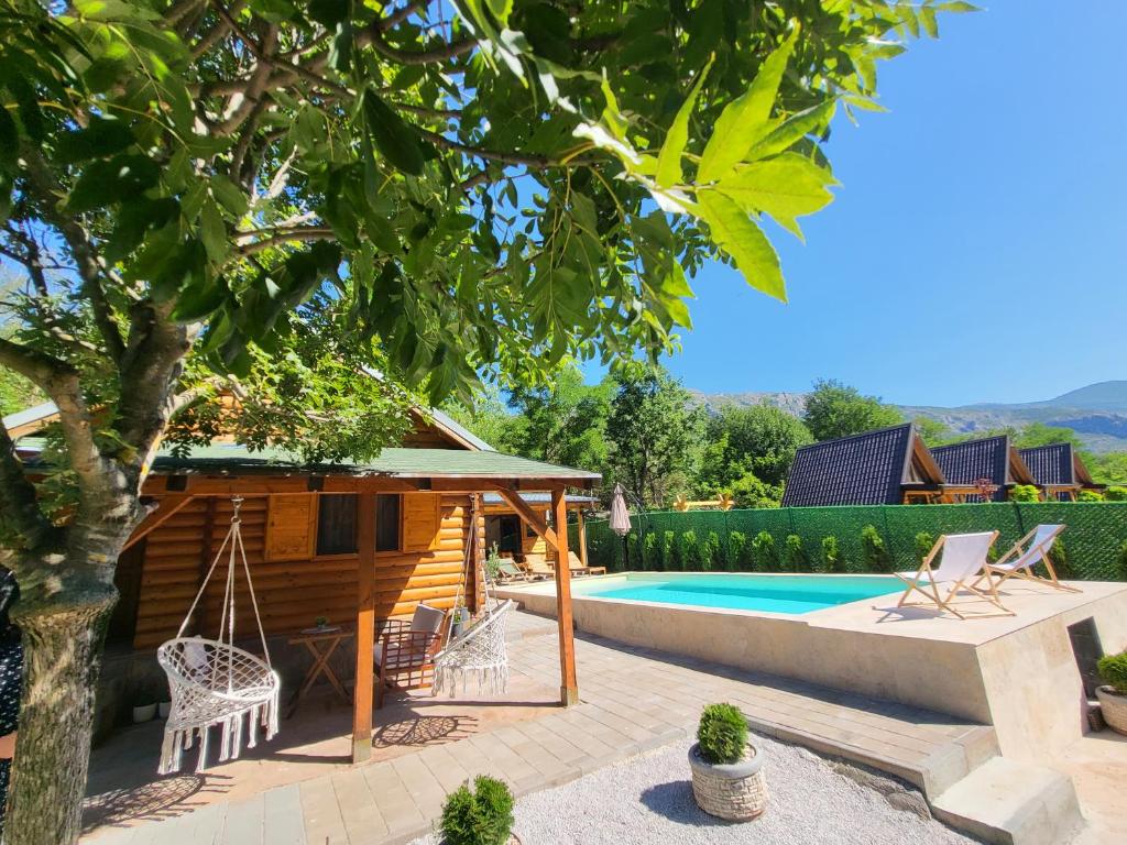 a villa with a swimming pool and a house at PARADISO pool&house in Prosek
