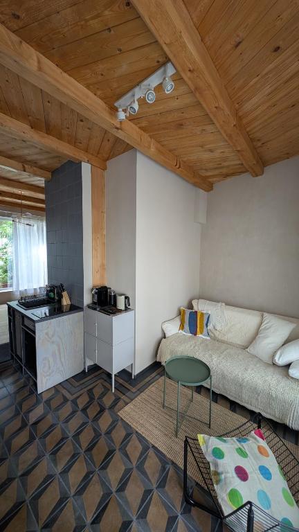 a living room with a couch and a table at Fachwerk Studio in Leipzig