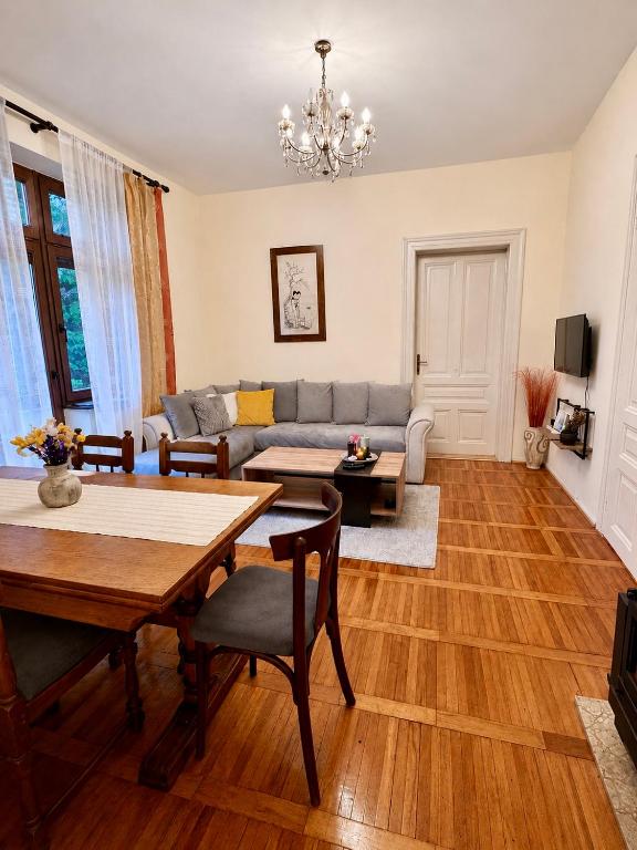 a living room with a table and a couch at Ljubez Apartment in Jajce