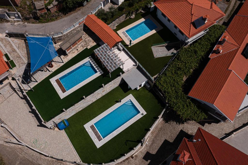 an overhead view of a house with two swimming pools at Casa Lagar in Vale de Cambra