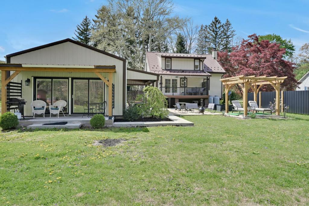 a house with a patio and a yard at Cozy Home Retreat by the River in Cressona