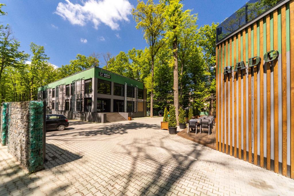 a building with a green and yellow building at Rado Hotel Spa in Khmilnyk