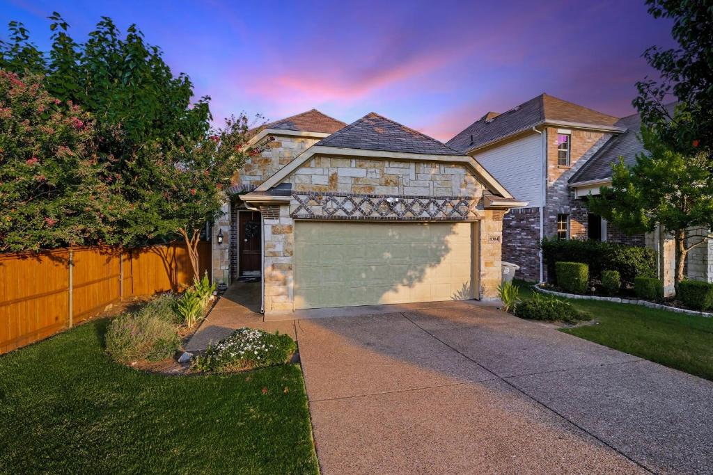 a house with a garage in the yard at Spacious 5-BD 3-BA Forest View Getaway Sleeps 13 in Dallas