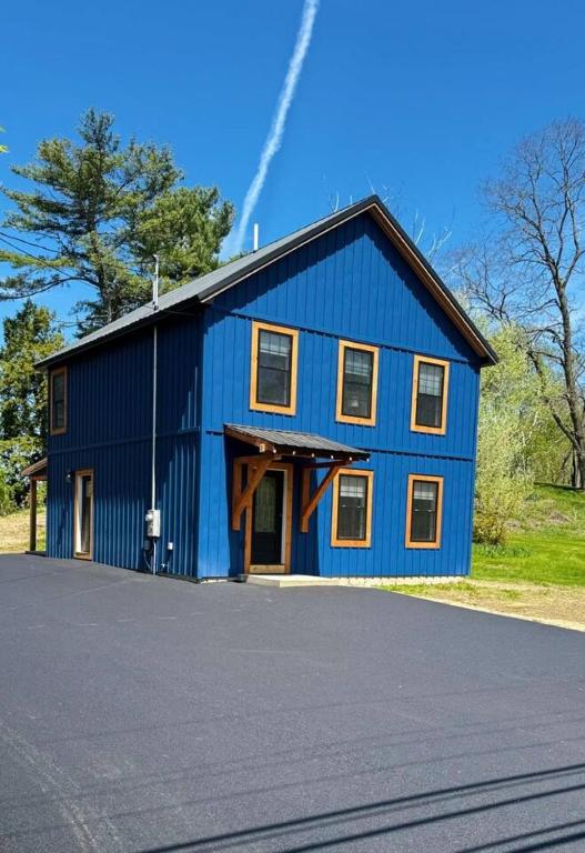 a blue house with a gambrel roof at New Riverside Fire Pit 3BR 2.5 bath in Brewer