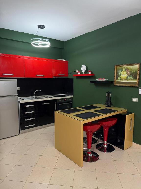a kitchen with red and green walls and a counter at Seaside Family Escape in Golem