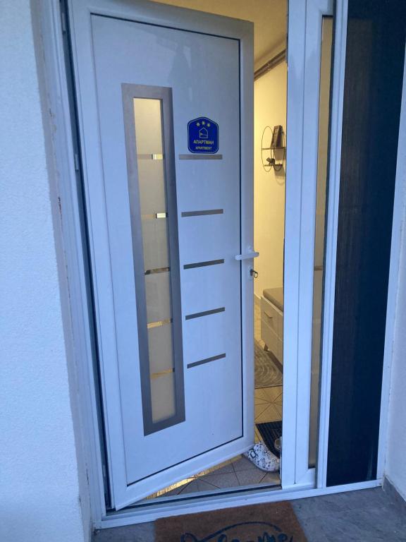 a door with a mirror and a sign on it at Nevade home in Gornji Milanovac
