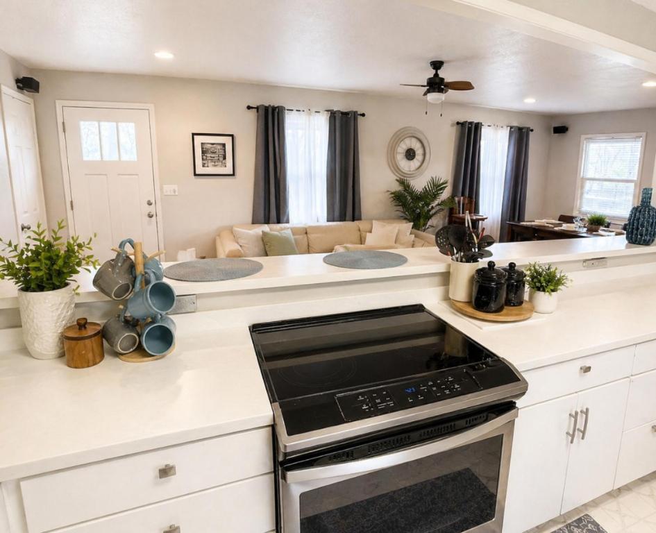 a kitchen with white cabinets and a stove top oven at Backwater Bliss 3BD, 2BA, Grill, Pet Friendly 20PP in Osage Beach