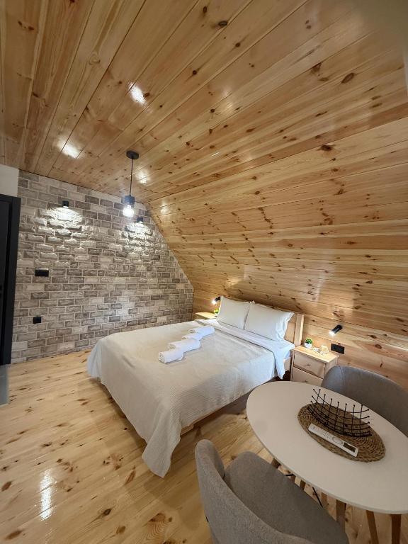 a bedroom with a bed and a table and chairs at Apartments S&S in Žabljak