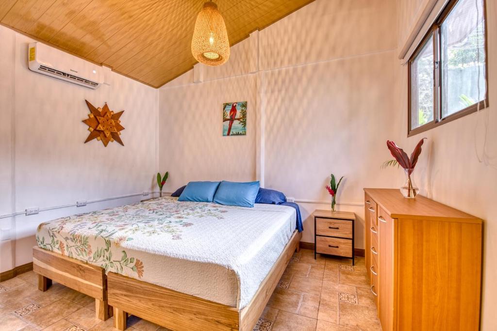 a bedroom with a bed and a wooden dresser at Beachfront Studio - King Bed - Fast WiFi - AC in Cocles