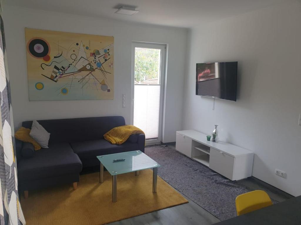 a living room with a couch and a tv at Haus Strandoase Nr 4 in Oldenburg in Holstein