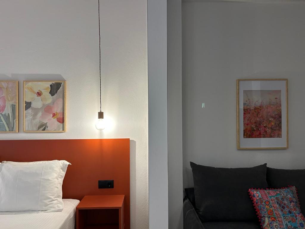 a hotel room with a bed and a couch at Avra Rooms in Limnionas