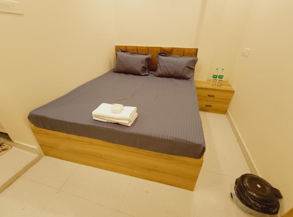 a bedroom with a bed with a towel on it at Hotel Mahakal Ujjain Prime in Ujjain