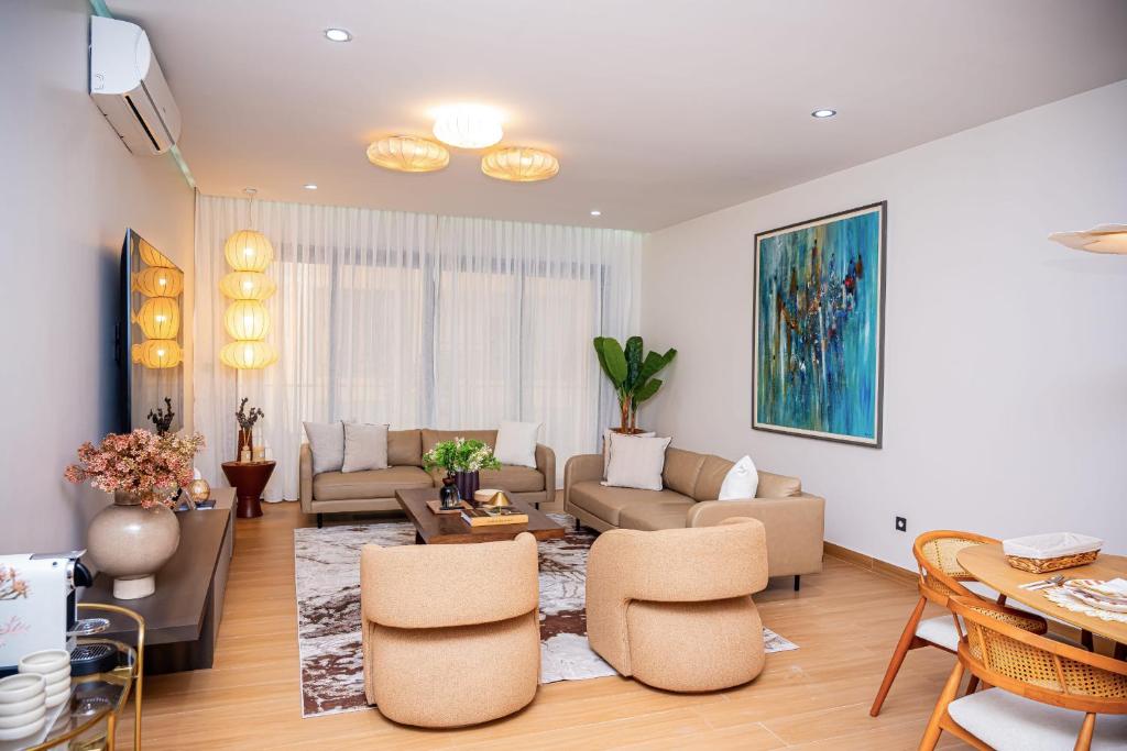 a living room with a couch and a table at Résidence LOBOS by Ilios in Dakar
