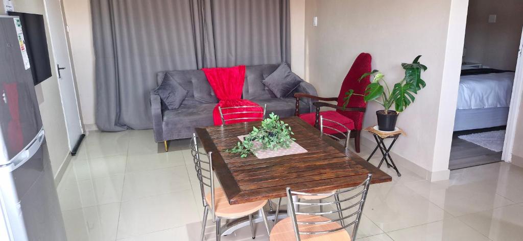a living room with a table and a couch at Simlily Place in East London